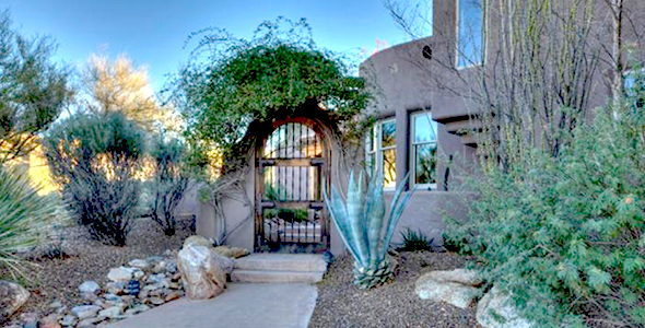 This North Scottsdale home for sale in the Troon area development of Saguaro Highlands is a beautiful custom home with mountain and city light views.